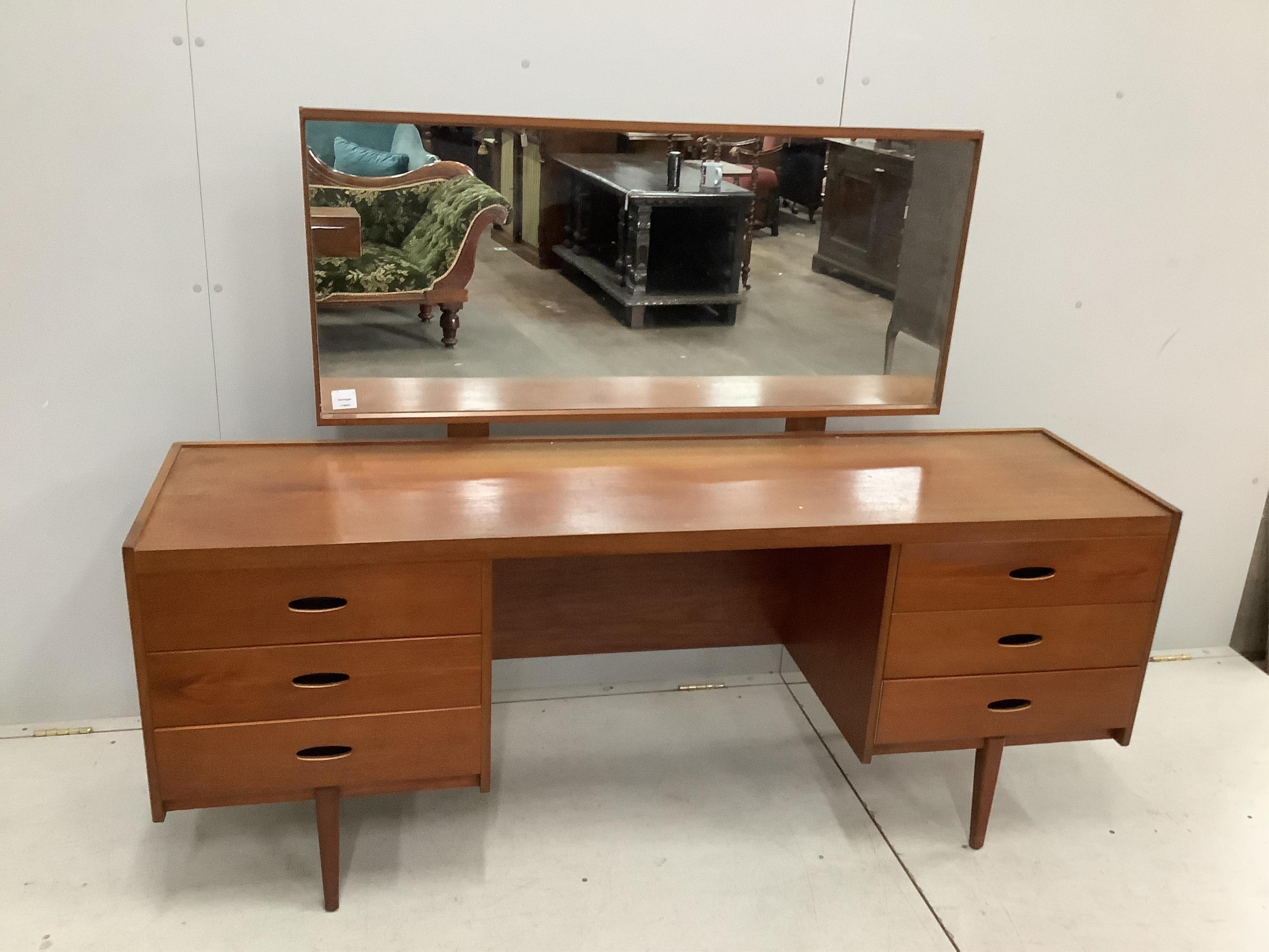 An Austin Suite teak dressing table, width 168cm, depth 44cm, height 126cm